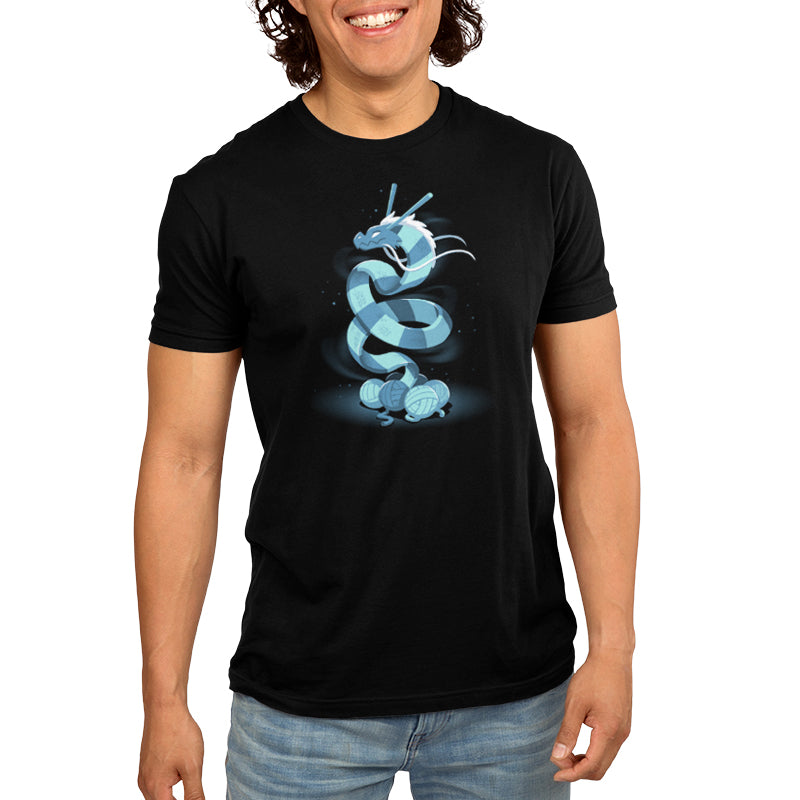 A man wearing a powerful and cozy TeeTurtle Knitted Dragon t-shirt with a blue dragon on it.