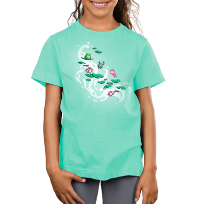 A girl in a comfortable Leaping Lily Pads T-shirt by TeeTurtle with an image of a lily pad.