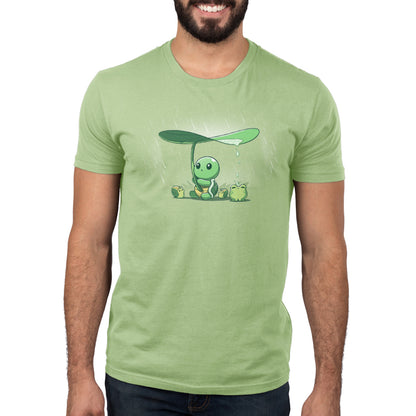 A man wearing a TeeTurtle sage green Little Critter Umbrella t-shirt.