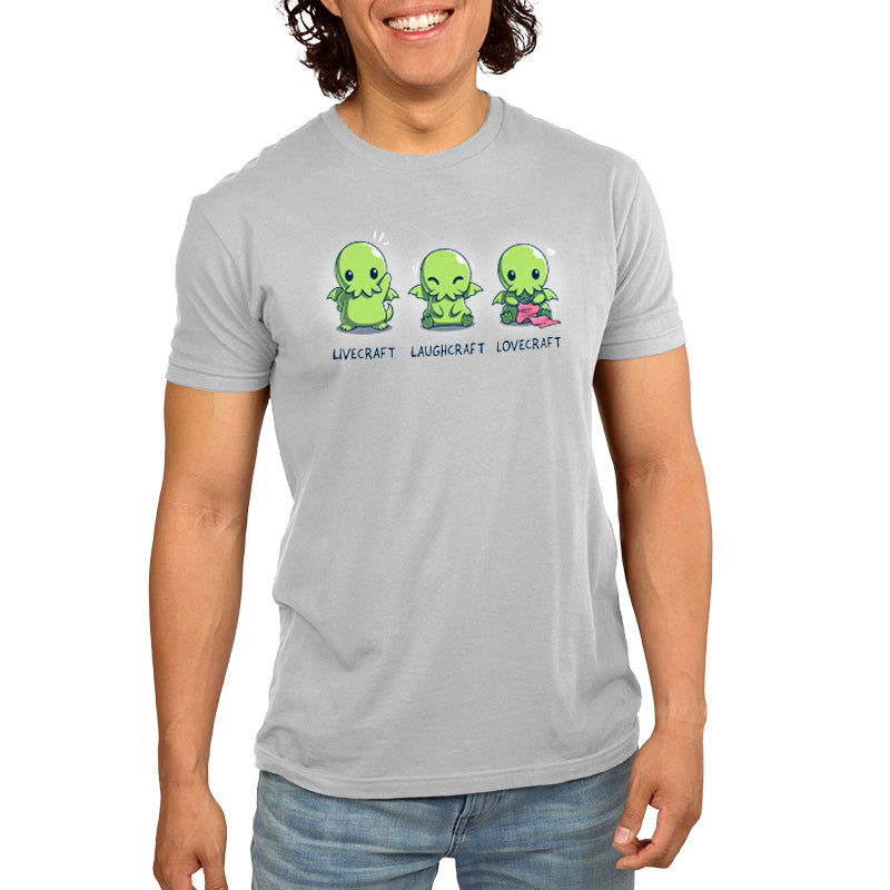 A man wearing a TeeTurtle Livecraft gray t-shirt with two green aliens.