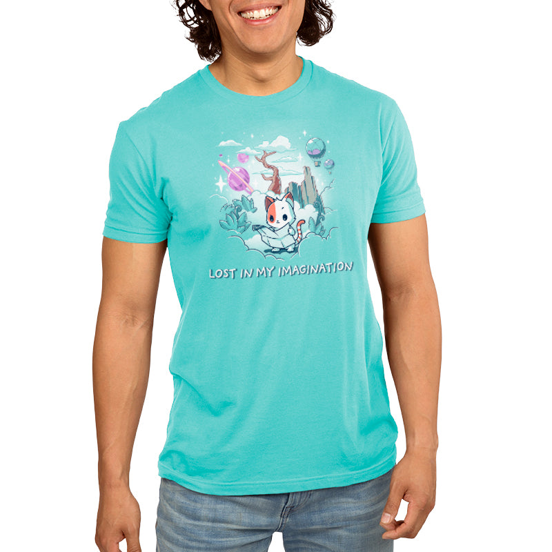 A man wearing a turquoise t-shirt with an image of a dog and a cat from TeeTurtle's Lost in My Imagination.