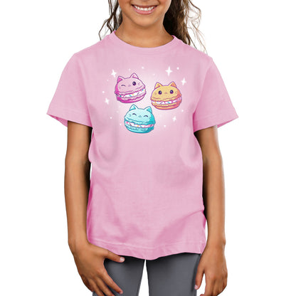 A girl wearing a pink t-shirt with three TeeTurtle Meowcarons cats on it.