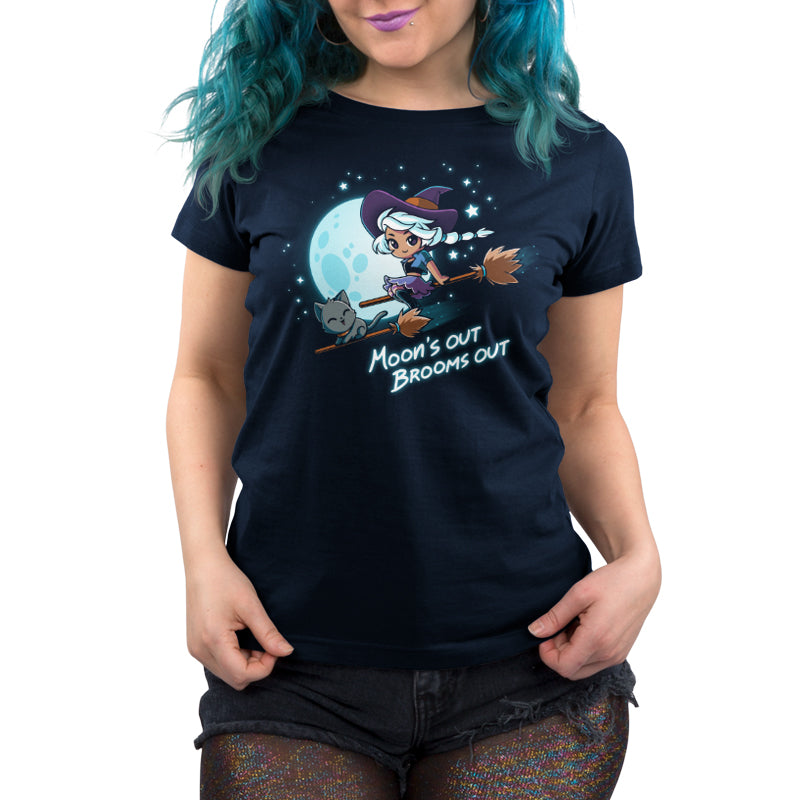 A Moon’s Out Brooms Out navy blue t-shirt with a witch on a broom by TeeTurtle.