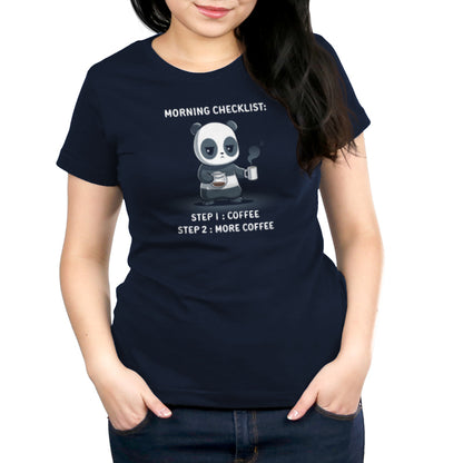 Person wearing a super soft ringspun cotton navy blue T-shirt featuring a cartoon panda with coffee, accompanied by text: "Morning Checklist: Step 1: Coffee, Step 2: More Coffee," by monsterdigital. Product Name: Morning Checklist.