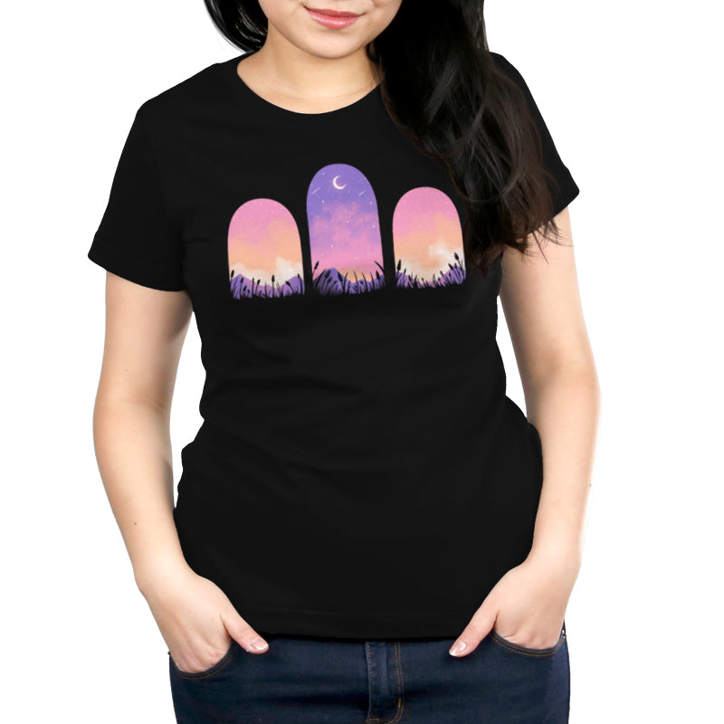 A woman wearing a black Mystic Triptych T-shirt made of ringspun cotton, designed by TeeTurtle, featuring a purple sky.