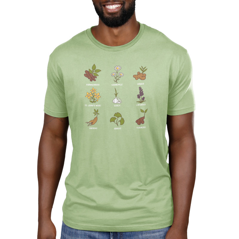 A man wearing a green t-shirt with different plants including Nature's Medicine's Chamomille and Ashwagandha on it, made by TeeTurtle.