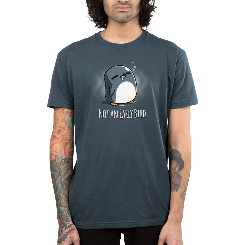 A penguin in a denim blue Not an Early Bird t-shirt that showcases comfort, made by TeeTurtle.