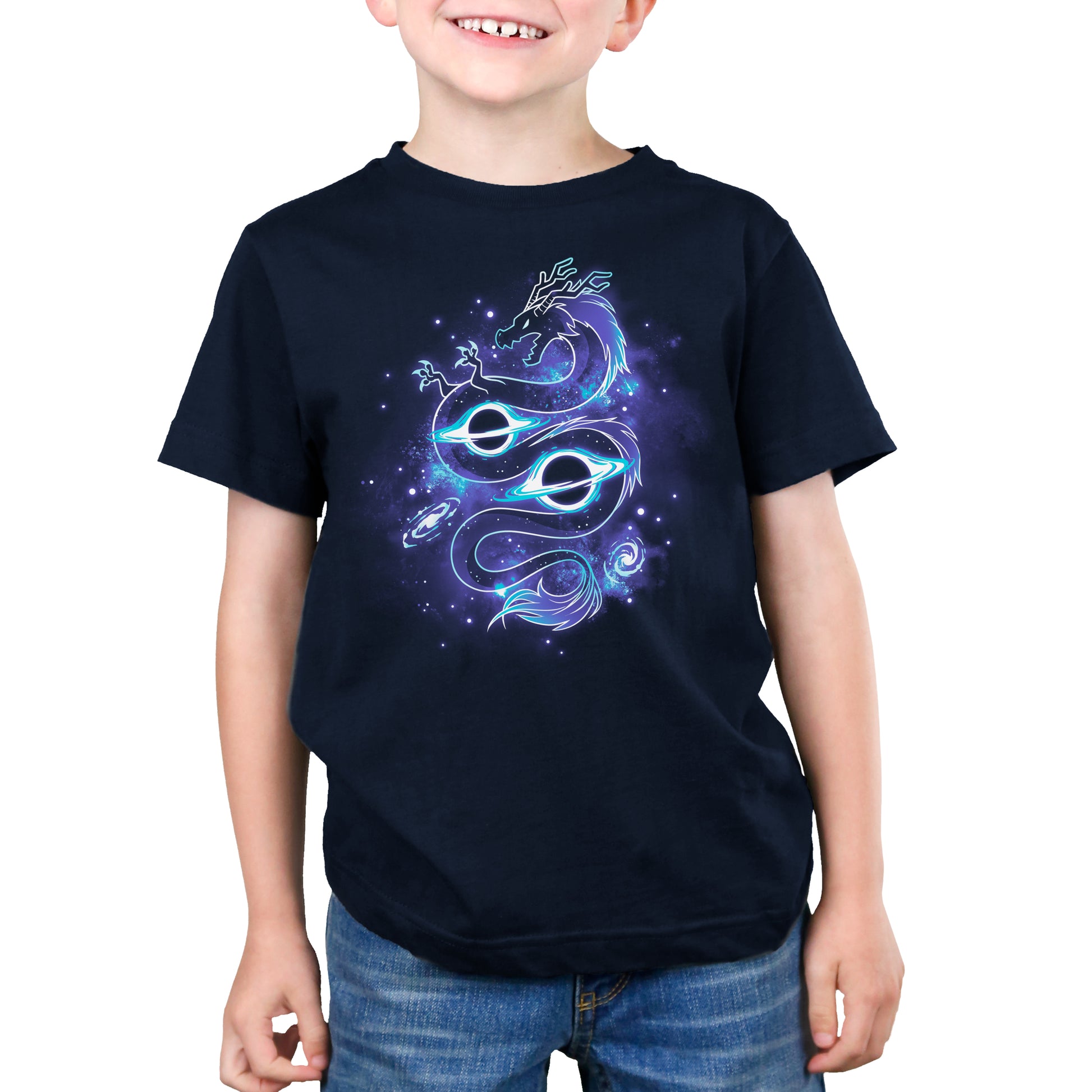 A young boy wearing a TeeTurtle Outer Space Dragon t-shirt.