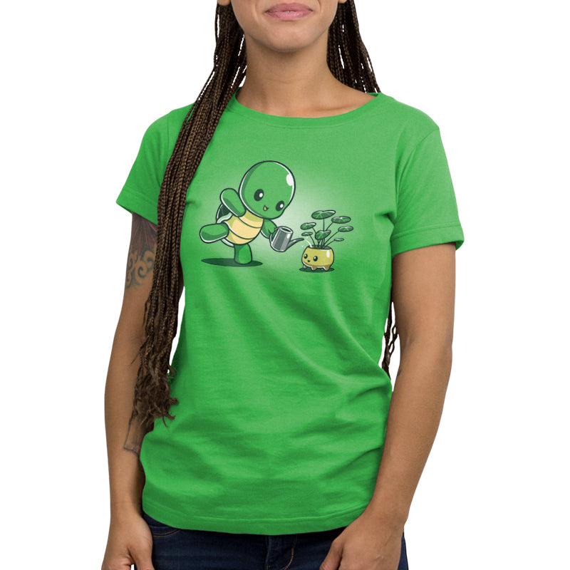 A woman wearing a TeeTurtle green t-shirt with a turtle on it, showcasing her TeeTurtle Plant Parenting skills.