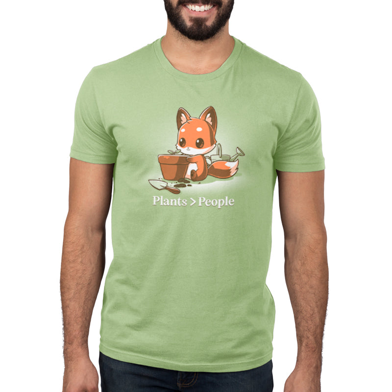 A green t-shirt with an image of a fox holding a pot, perfect for nature lovers, from the Plants > People brand TeeTurtle.