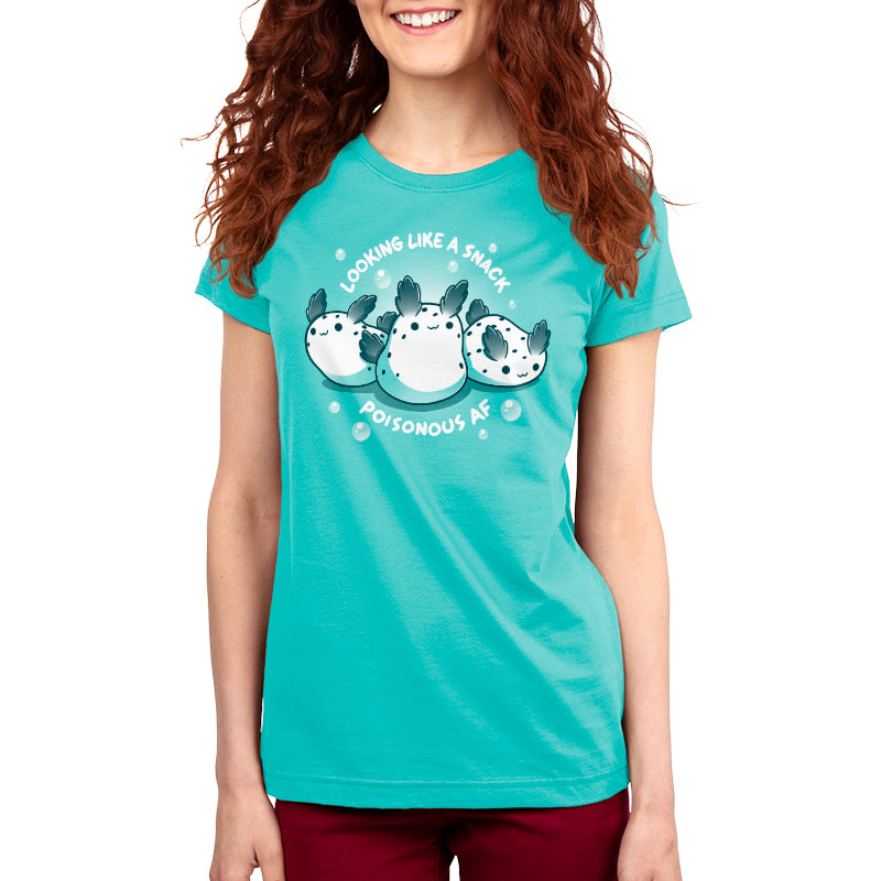 Premium Cotton T-shirt - Woman wearing a Caribbean blue apparel with a graphic of three pufferfish and the text "Looking like a snack, **Poisonous AF**." The woman has red hair and is standing against a white background. The apparel is made by **monsterdigital**.