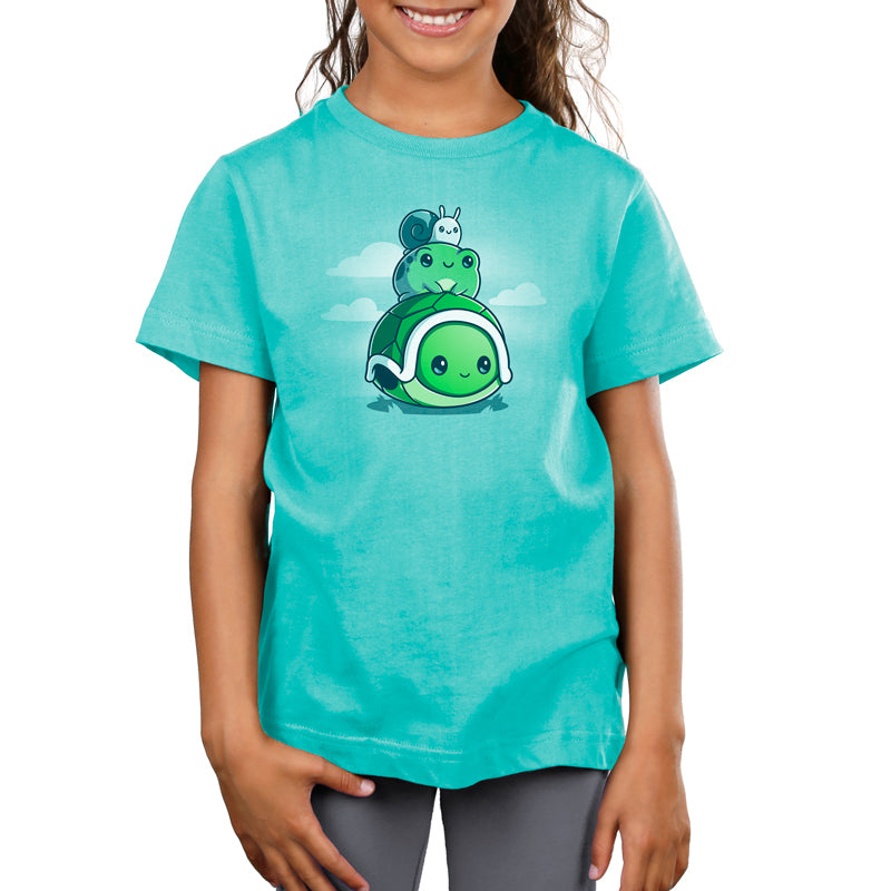 A girl wearing a Pond Pals teal t-shirt with a cartoon turtle on it from TeeTurtle.
