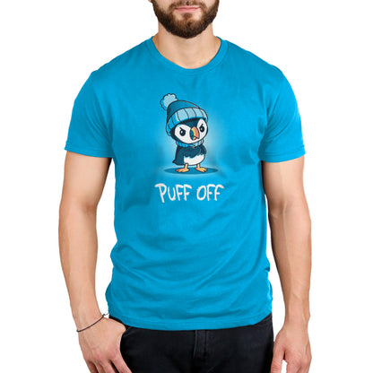 A man wearing a cobalt blue Puff Off t-shirt with a penguin on it from TeeTurtle.