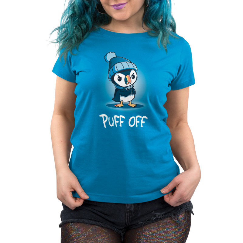 A woman wearing a TeeTurtle Puff Off blue t-shirt with a penguin on it.