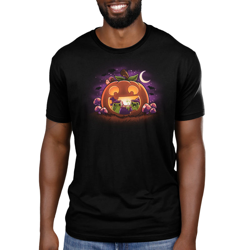 A man in a comfortable TeeTurtle Pumpkin Frog Witches T-shirt.