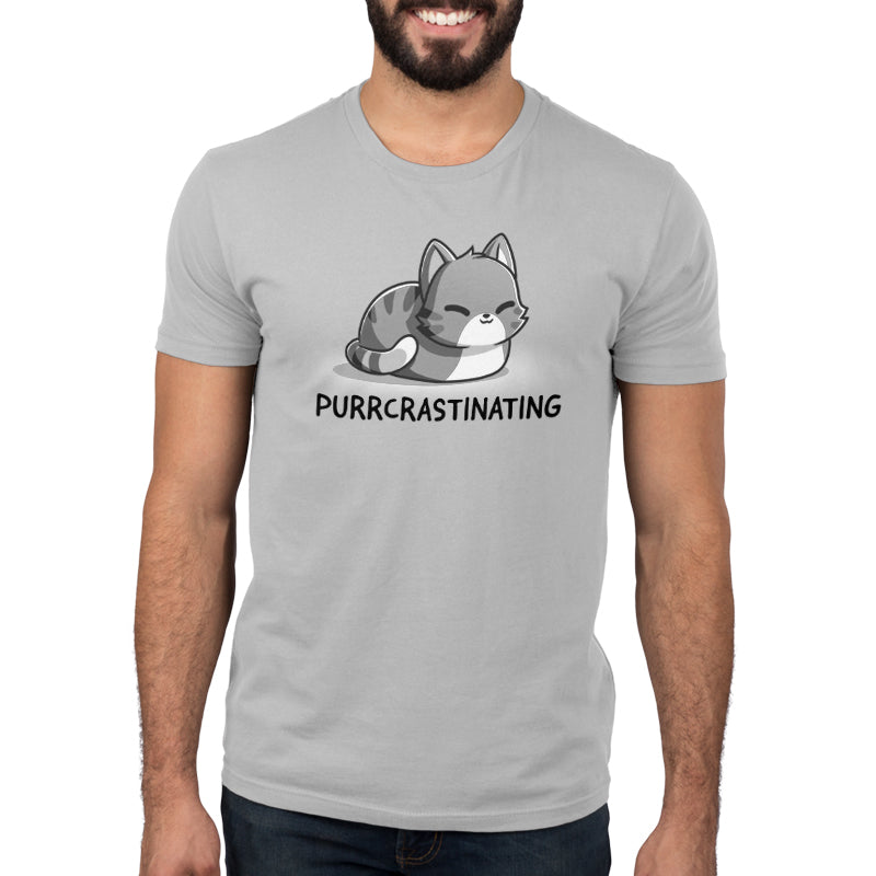 A man wearing a grey t-shirt from TeeTurtle with the product "Purrcrastinating" from the brand TeeTurtle written on it.