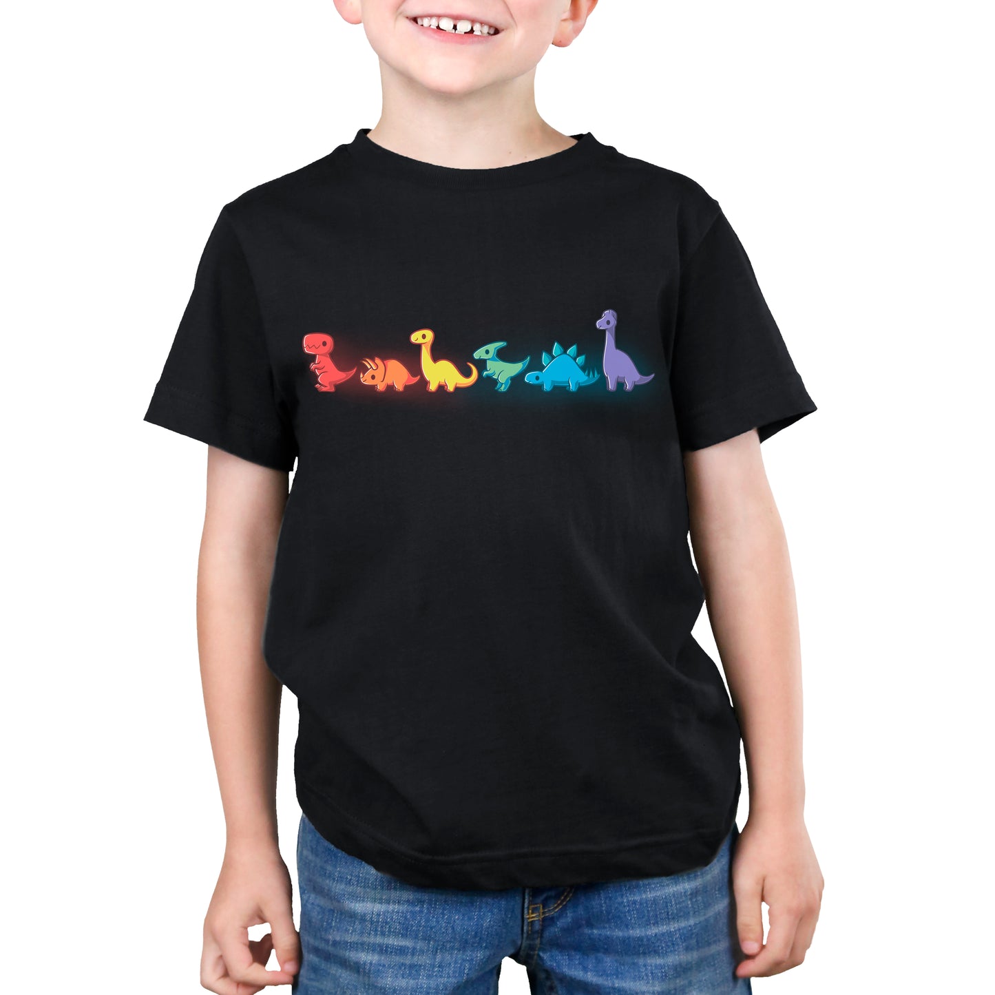 A young boy wearing a Dino-mite black t-shirt with TeeTurtle Rainbow Dinos.