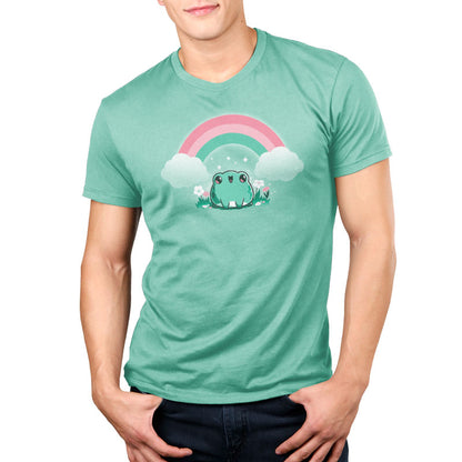 A man wearing a green TeeTurtle Rainbow Ribbits t-shirt with a magic rainbow and a smol ribbit frog.