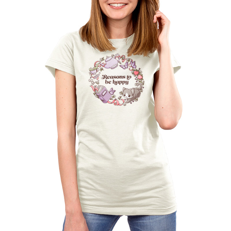 A woman wearing a comfortable Reasons to be Happy t-shirt adorned with flowers and butterflies made by TeeTurtle