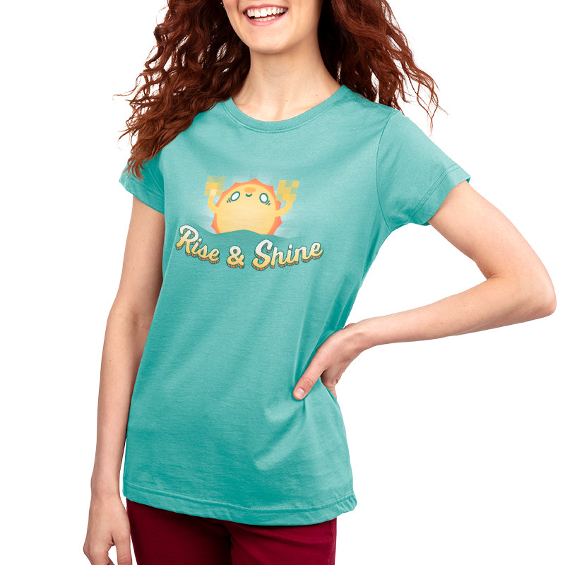 A woman wearing a teal Rise & Shine t-shirt made of Ringspun Cotton by TeeTurtle.