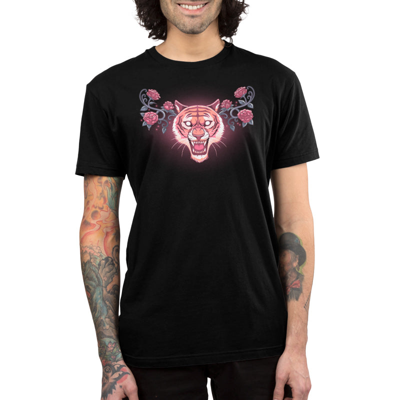 A man wearing a black t-shirt with a Roar and Roses pink tiger on it, TeeTurtle.