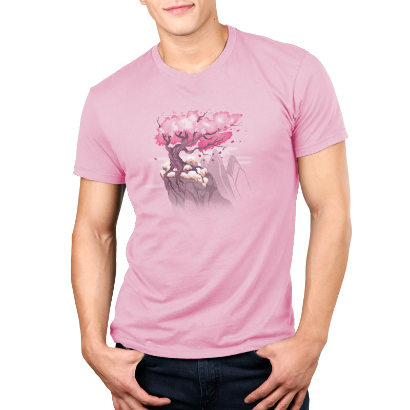 A man wearing a pink TeeTurtle Sakura Tree ringspun cotton T-shirt with the beauty of blossoms on it.