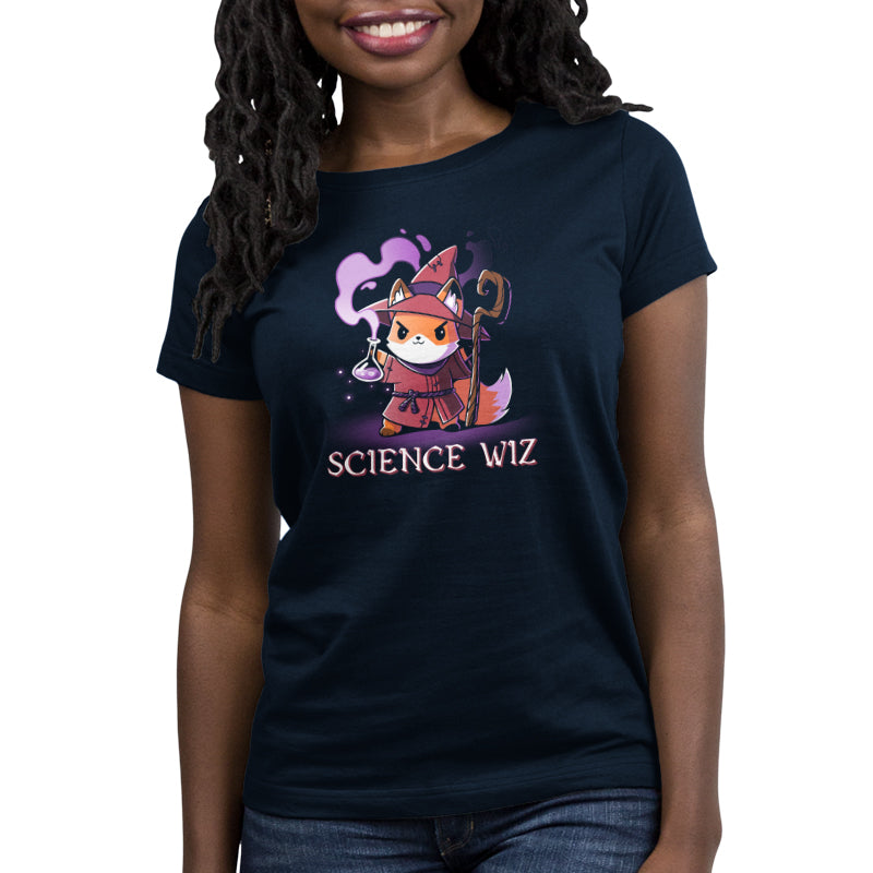 A person wearing a super soft ringspun cotton navy blue t-shirt featuring a cartoon fox dressed as a wizard with a flask and the text "Science Wiz" below the image. The product, Science Wiz, is made by monsterdigital.