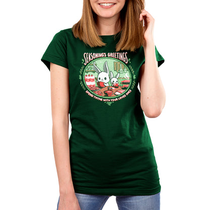 A woman wearing a green Seasoning's Greetings t-shirt with a Christmas tree on it. Brand name is TeeTurtle.