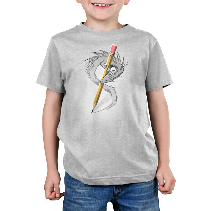 A young boy wearing a comfortable gray Sketchbook Dragon t-shirt by TeeTurtle with a pencil drawing on it.