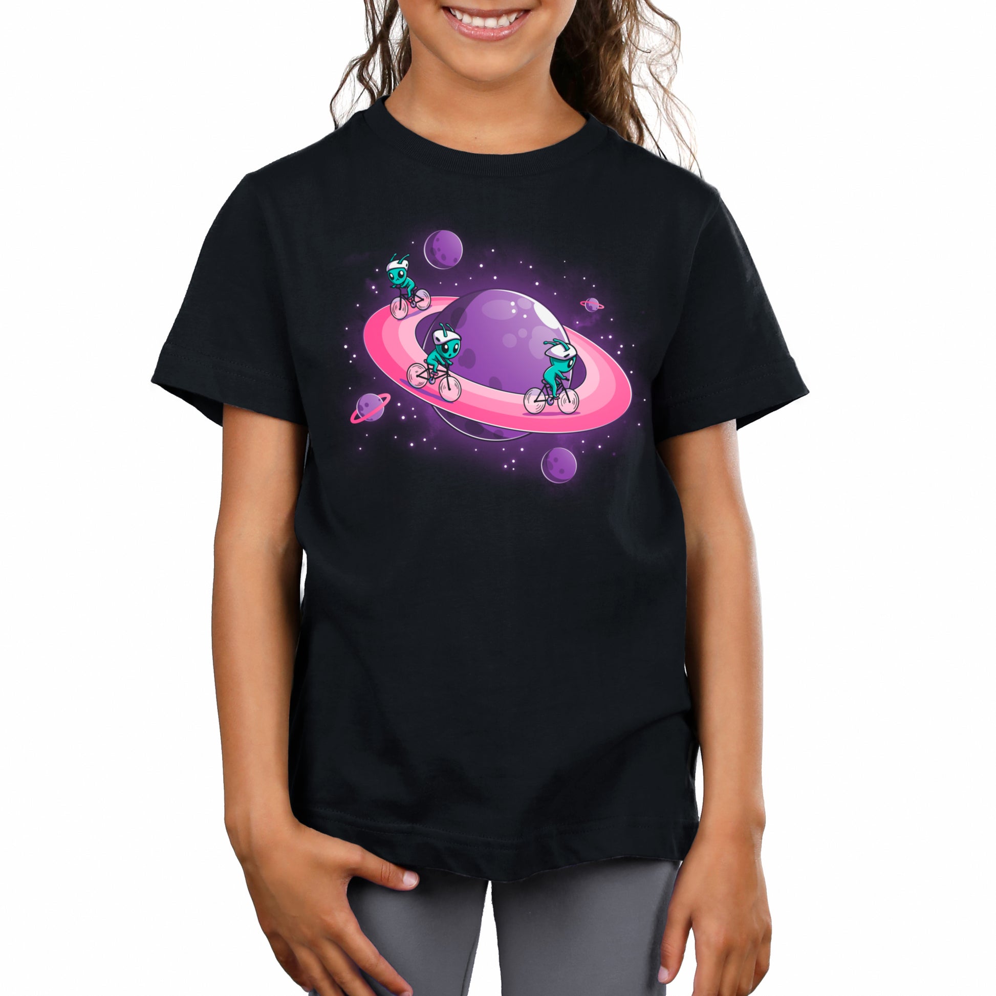 Child wearing a black unisex Space Race tee from TeeTurtle with a colorful graphic of cartoon characters in space.