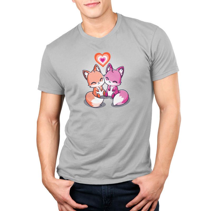 A man wearing a grey t-shirt featuring two foxes holding hearts called Love Out Loud by TeeTurtle.