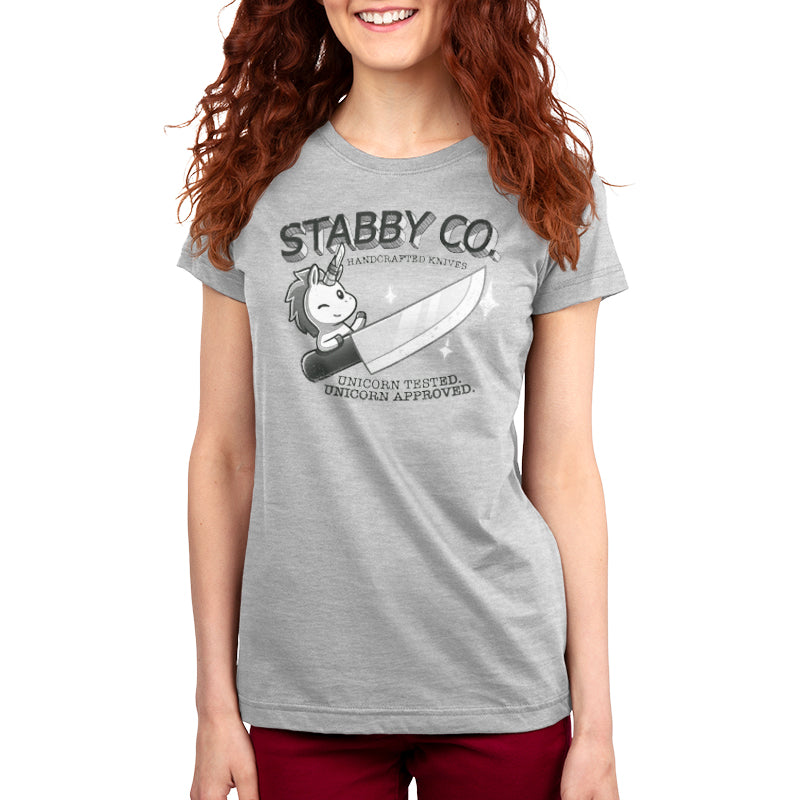 A woman wearing a TeeTurtle handcrafted T-shirt from Stabby's that says "Staby Co. Handcrafted Knives.