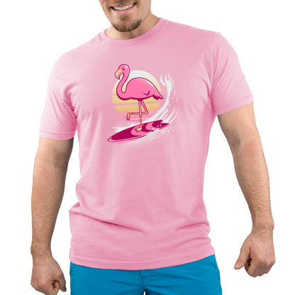A man on a Surfing Flamingo surfboard wearing a TeeTurtle pink flamingo t-shirt.