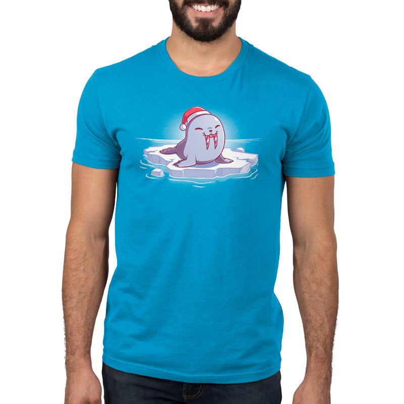 A man with a Sweet Tooth wearing a blue TeeTurtle T-shirt and a Santa hat.