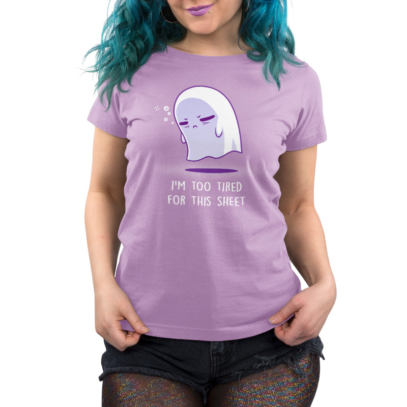 A woman wearing a lavender t-shirt with the brand "TeeTurtle" and the product name "I'm Too Tired for This Sheet" on it.