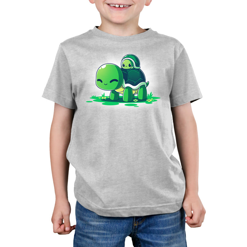A young boy wearing a comfortable gray Turtleback Ride T-shirt from TeeTurtle.