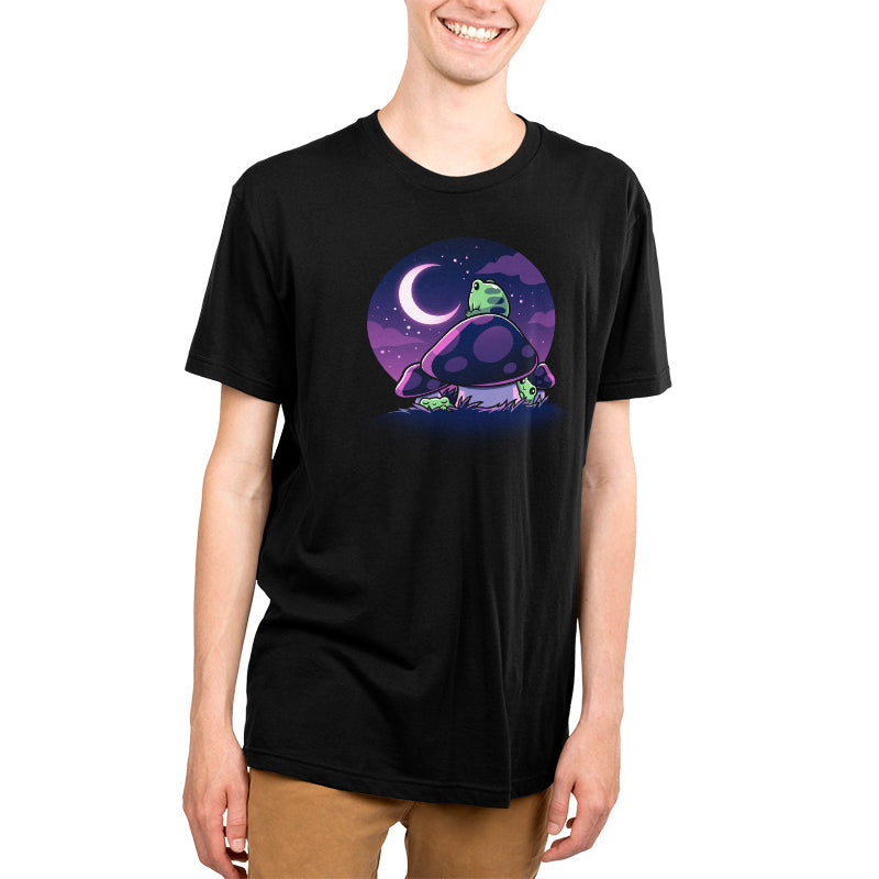 A young man wearing a black t-shirt stargazing on the moon with Twilight Toadstools by TeeTurtle.