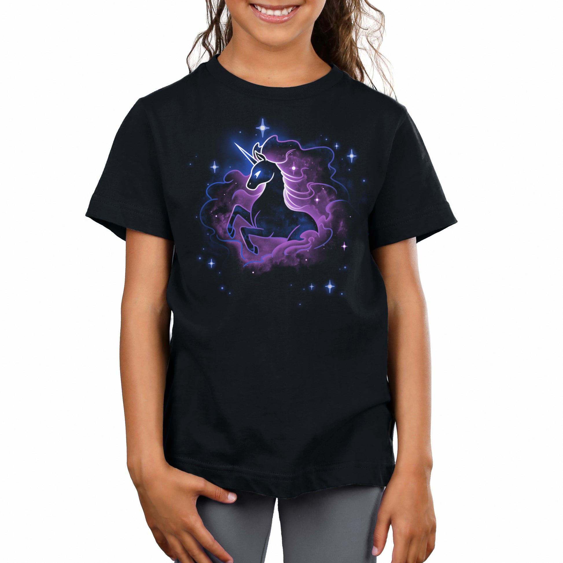 A girl wearing a Unicorn Nebula t-shirt from TeeTurtle with an image of a unicorn.