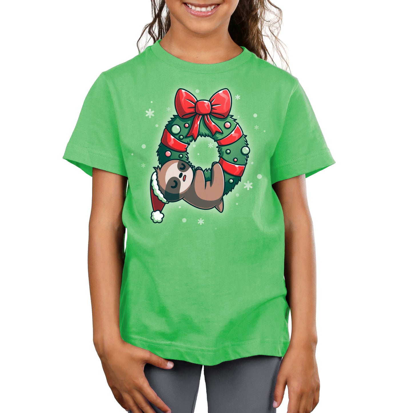 A girl wearing a TeeTurtle t-shirt with "We Wish You a Lazy Christmas" sloth on it.