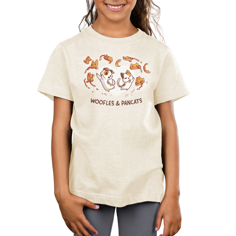 A girl wearing a sympathetically designed Woofles & Pancats t-shirt with monkey and leaf illustrations from TeeTurtle.