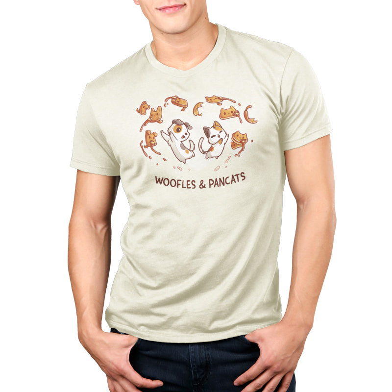 A man wearing a TeeTurtle Woofles & Pancats men's T-shirt with moose and ducks print.