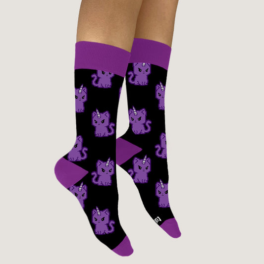 A woman wearing TeeTurtle Kittencorn Socks with cats on them.