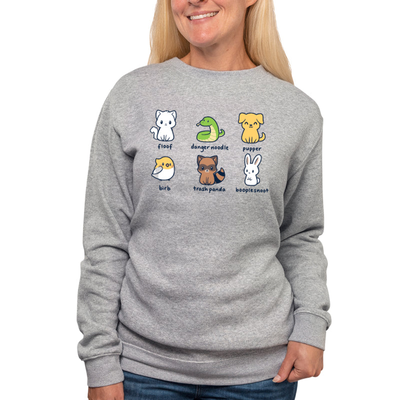 A woman wearing a gray sweatshirt with Animal Names on it, featuring TeeTurtle's Danger Noodle print.