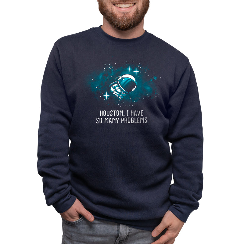 A man wearing a navy blue sweatshirt from TeeTurtle that says, "Houston, I Have So Many Problems.