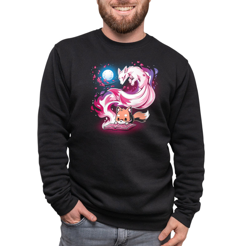 A man wearing a black sweatshirt with an image of Tale of Tails from TeeTurtle on it.