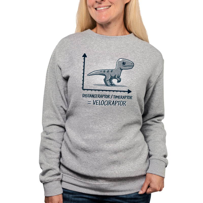 A woman wearing a gray Velociraptor T-shirt with the TeeTurtle brand on it.