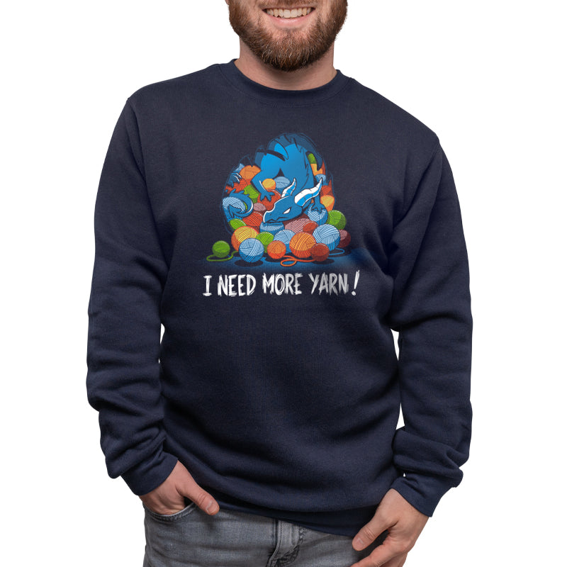 A man wearing a navy blue sweatshirt branded by TeeTurtle with the phrase "i need more you" featuring the Yarn Hoarder design.
