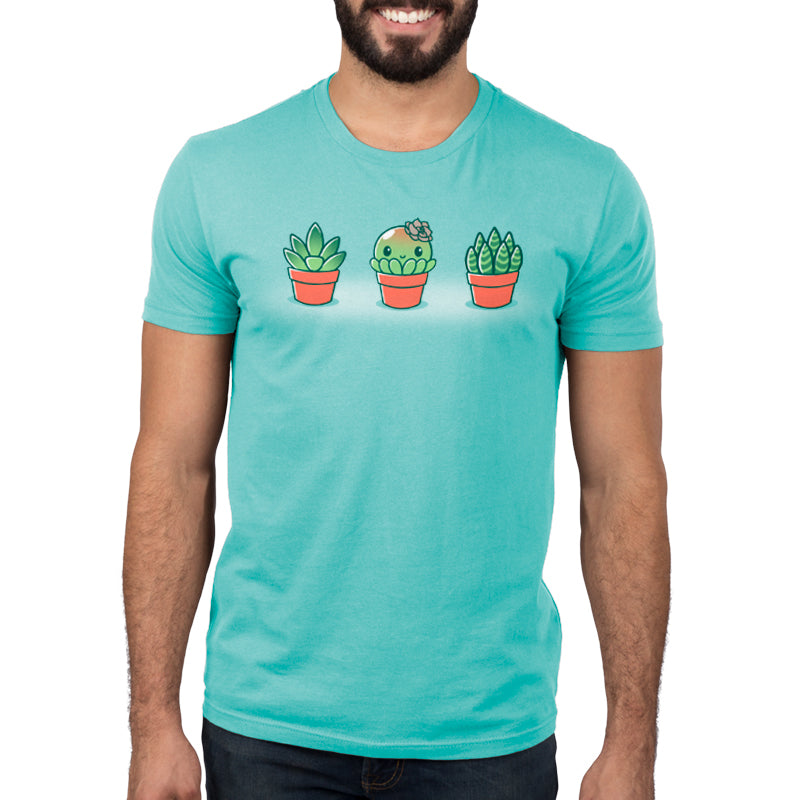 A man wearing a turquoise TeeTurtle t-shirt with Succulent Surprise plants on it.