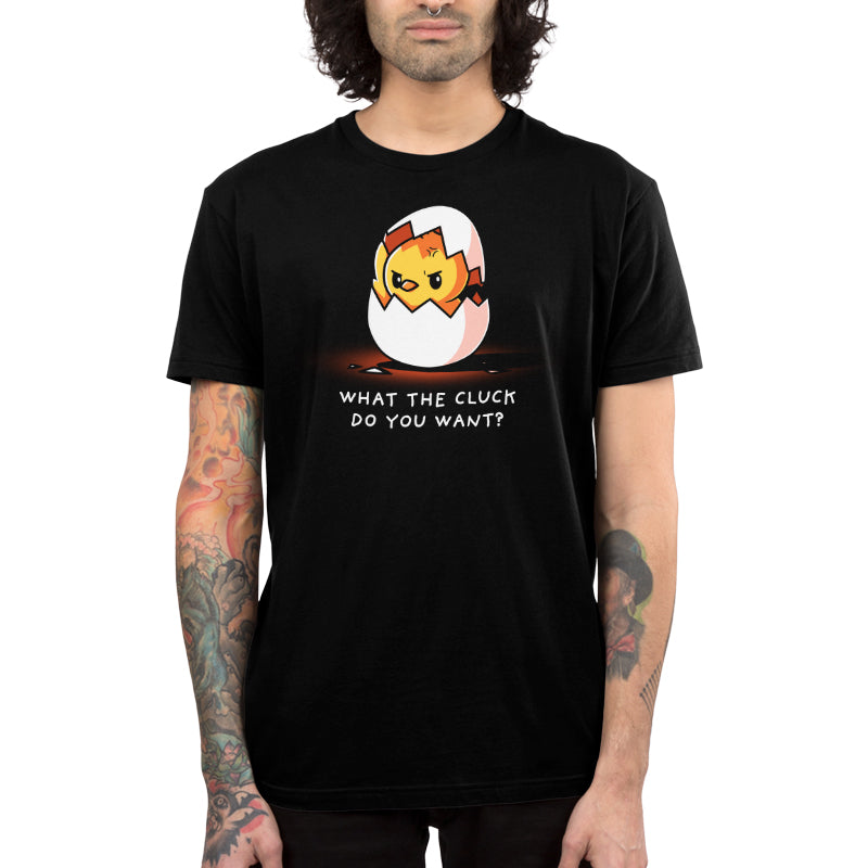 Premium Cotton T-shirt - Person wearing a black unisex apparelfeaturing a broken egg with an angry face and the text "What the Cluck Do You Want?." This super soft ringspun cotton apparel is both comfortable and attention-grabbing. The What the Cluck Do You Want? by monsterdigital adds a playful yet bold statement to any wardrobe.