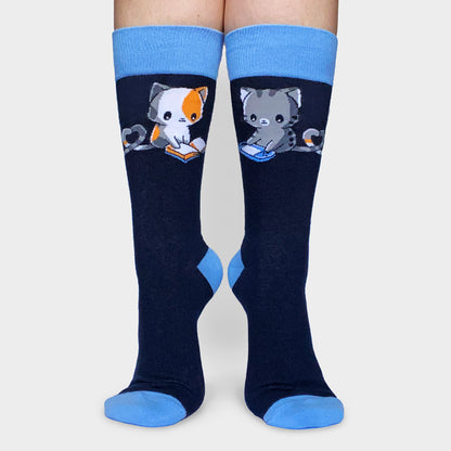 A pair of Let's Be Alone Together Socks by TeeTurtle with cats on them.